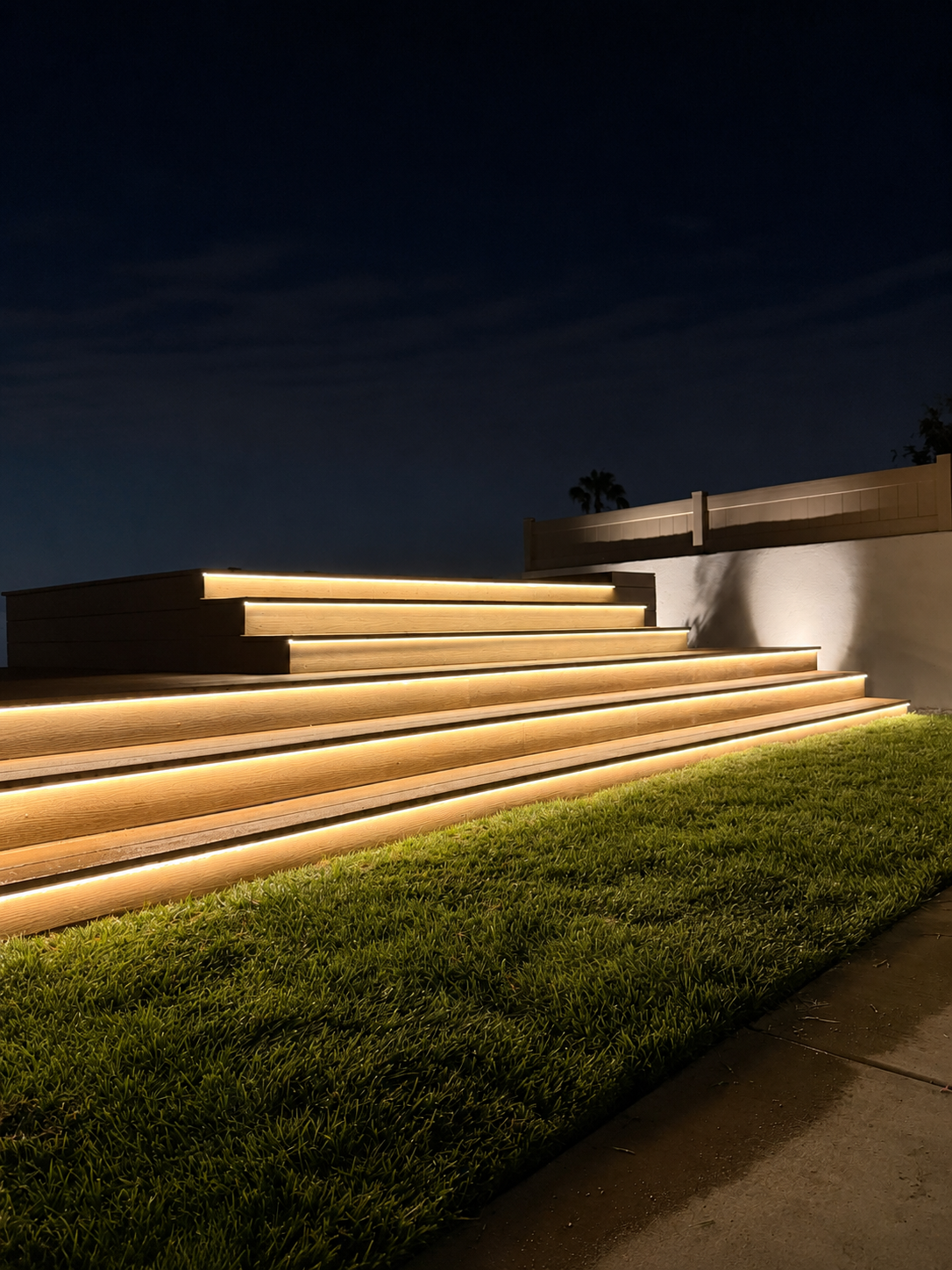 LED Riser Lighting on Tiered Composite Deck Steps by Moda Outdoor Living in Palos Verdes, CA — luxury outdoor living design and build