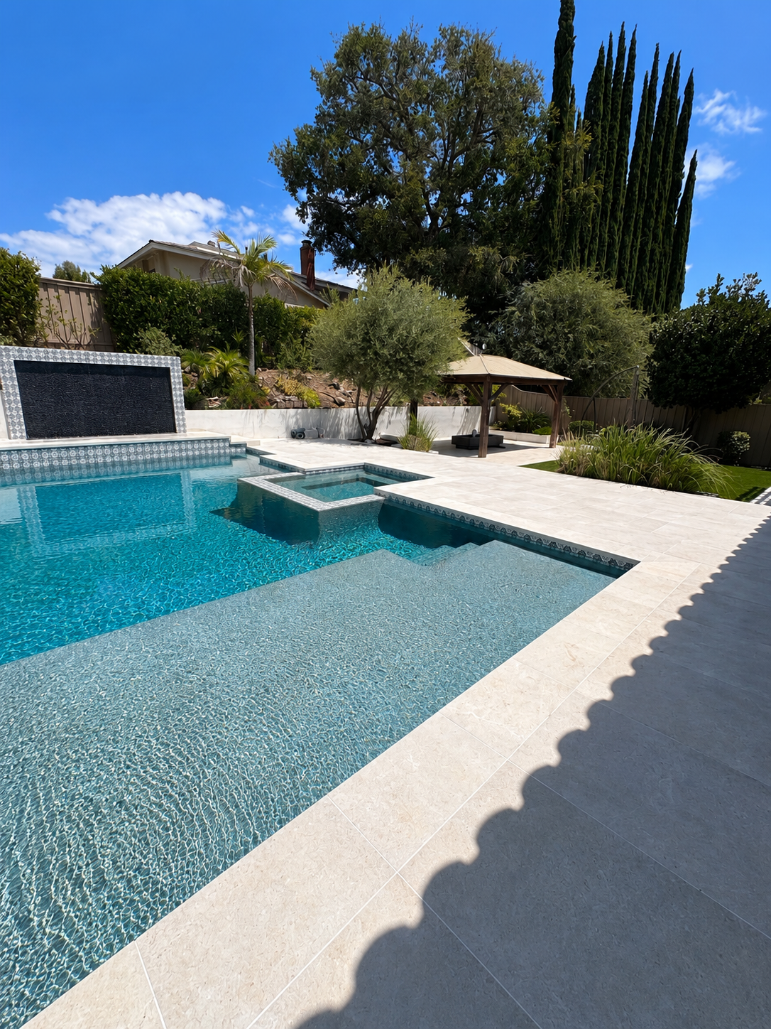 Travertine Pool Deck with Raised Spa, Water Wall & Cabana by Moda Outdoor Living in Westlake Village, CA — luxury outdoor living design and build