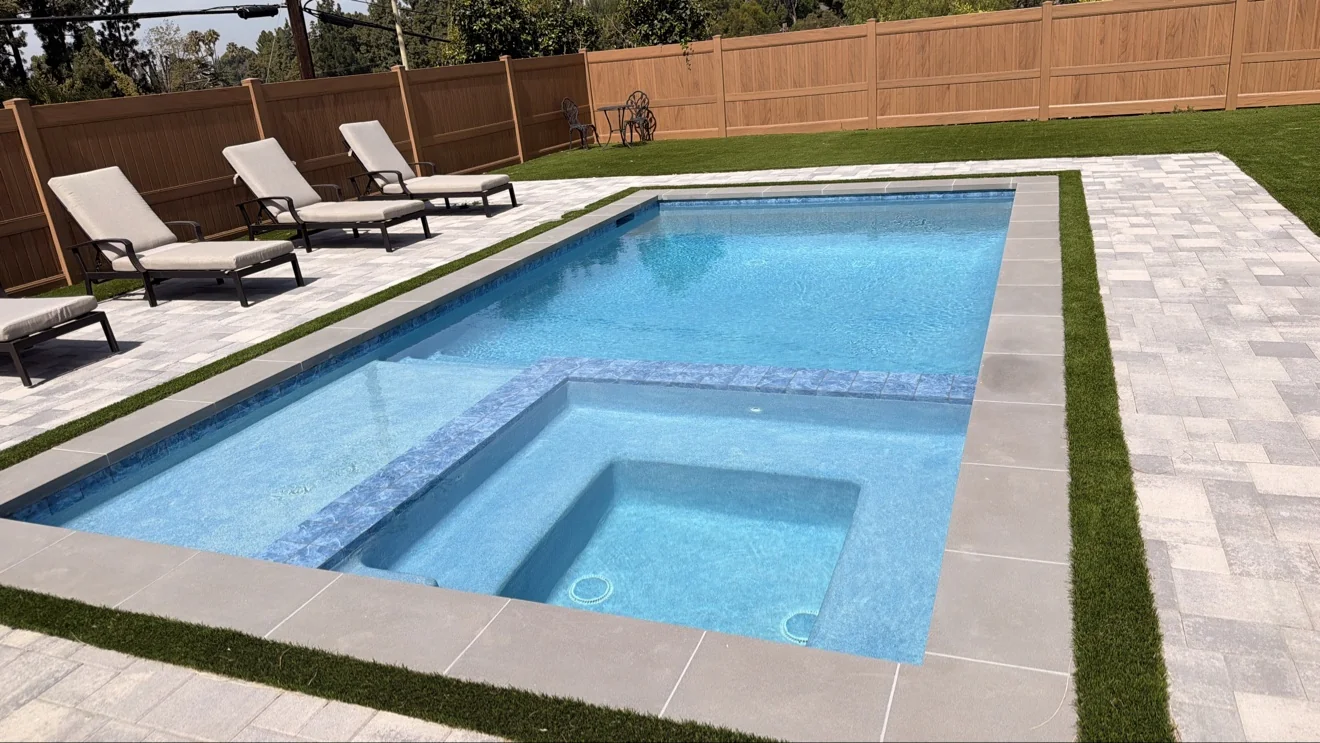 Pool and spa with turf accents by Moda Outdoor Living in Granada Hills, CA — luxury outdoor living design and build