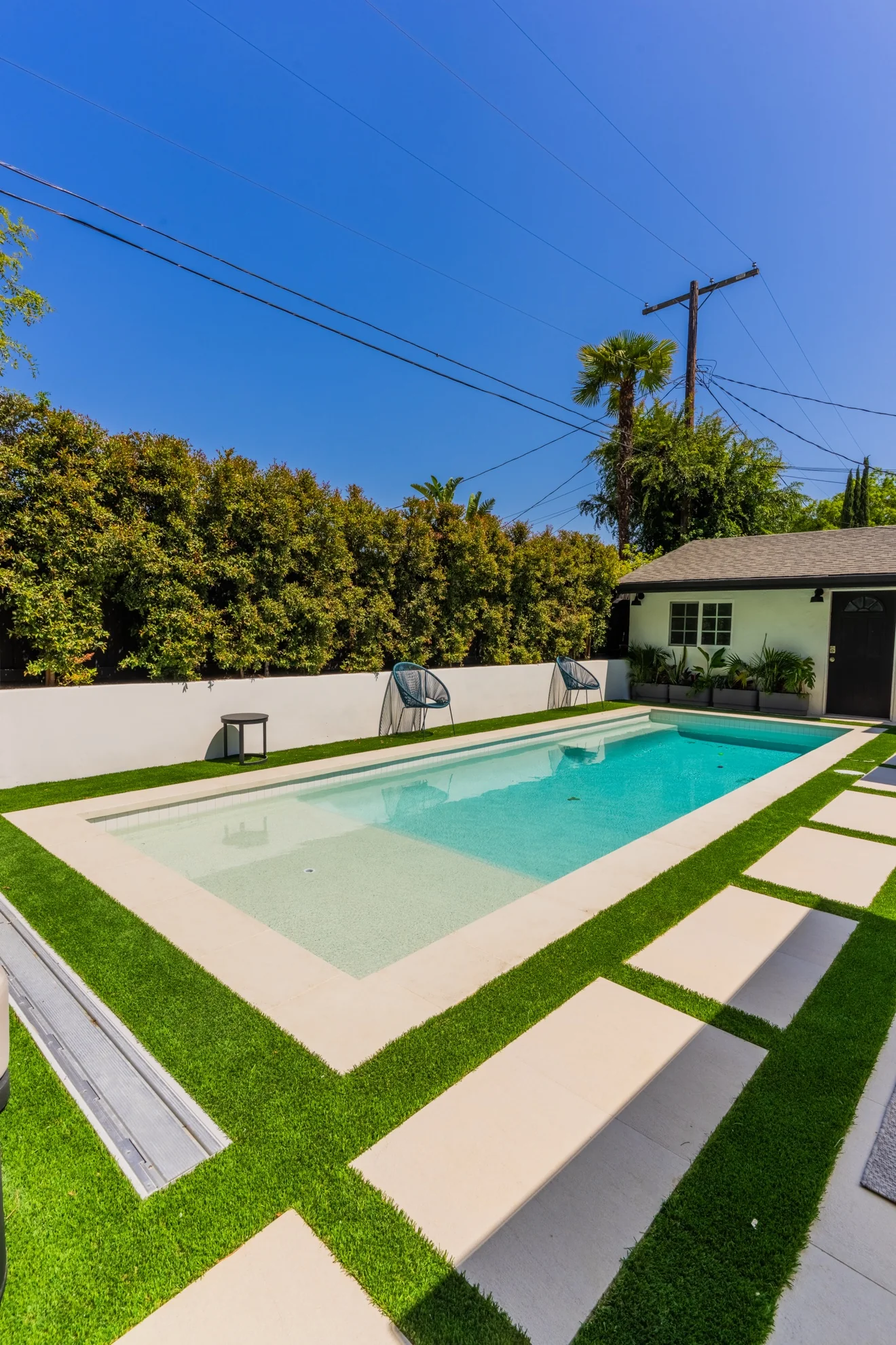 Pool with turf and paver grid by Moda Outdoor Living in Sherman Oaks, CA — luxury outdoor living design and build