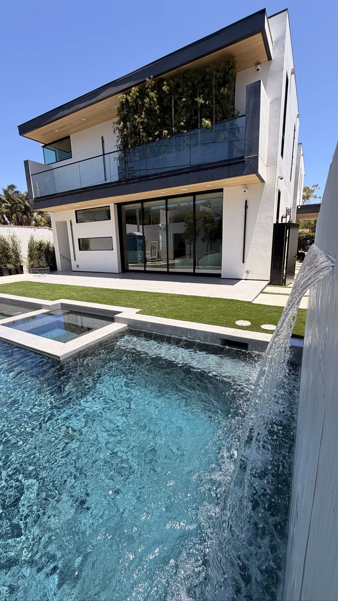 Pool, spa and waterfall wall by Moda Outdoor Living in Beverly Hills, CA — luxury outdoor living design and build
