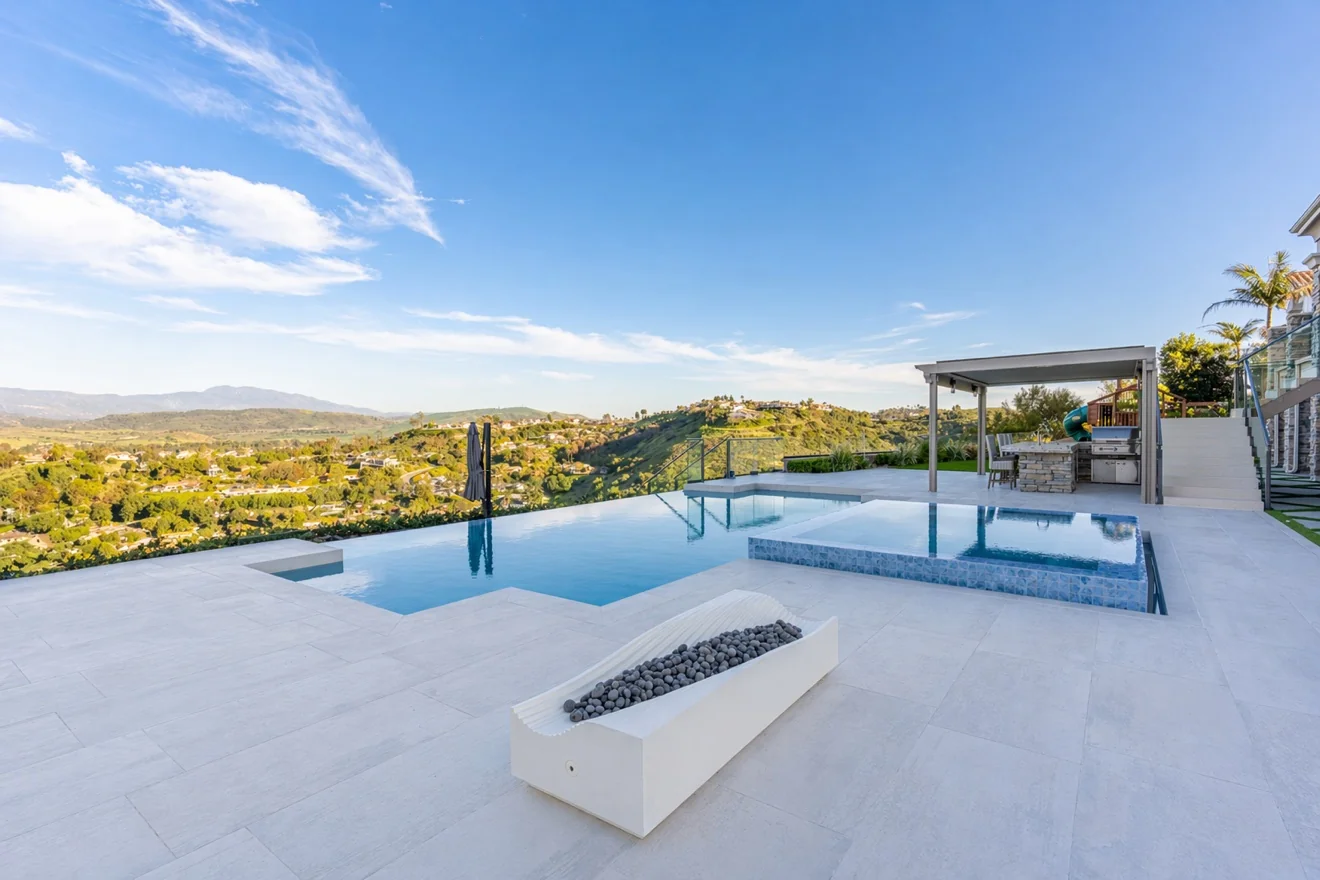 Infinity pool with raised spa and deck jets by Moda Outdoor Living in Orange County, CA — luxury outdoor living design and build