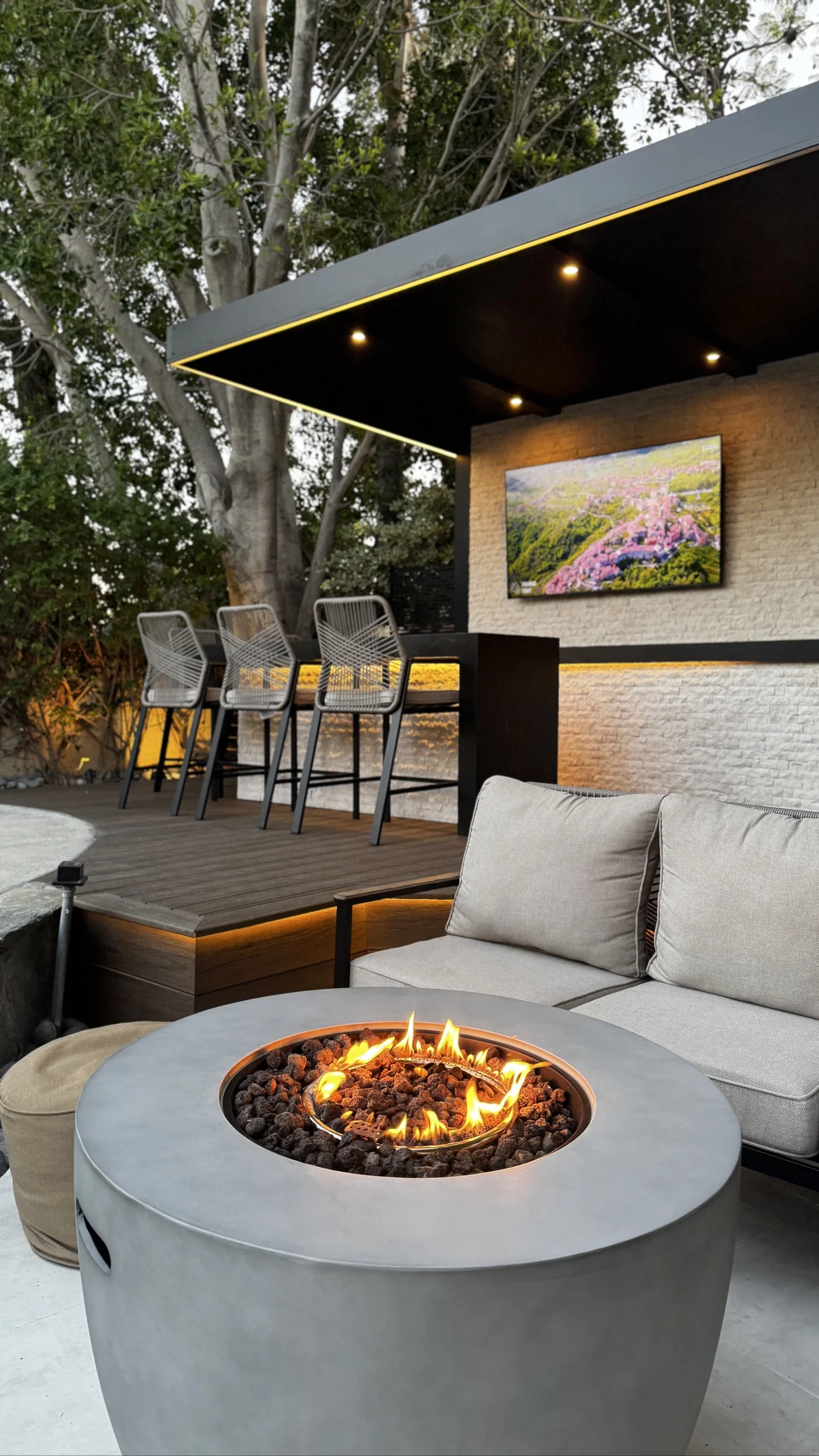 Fire pit and bar seating at dusk by Moda Outdoor Living in Porter Ranch, CA — luxury outdoor living design and build