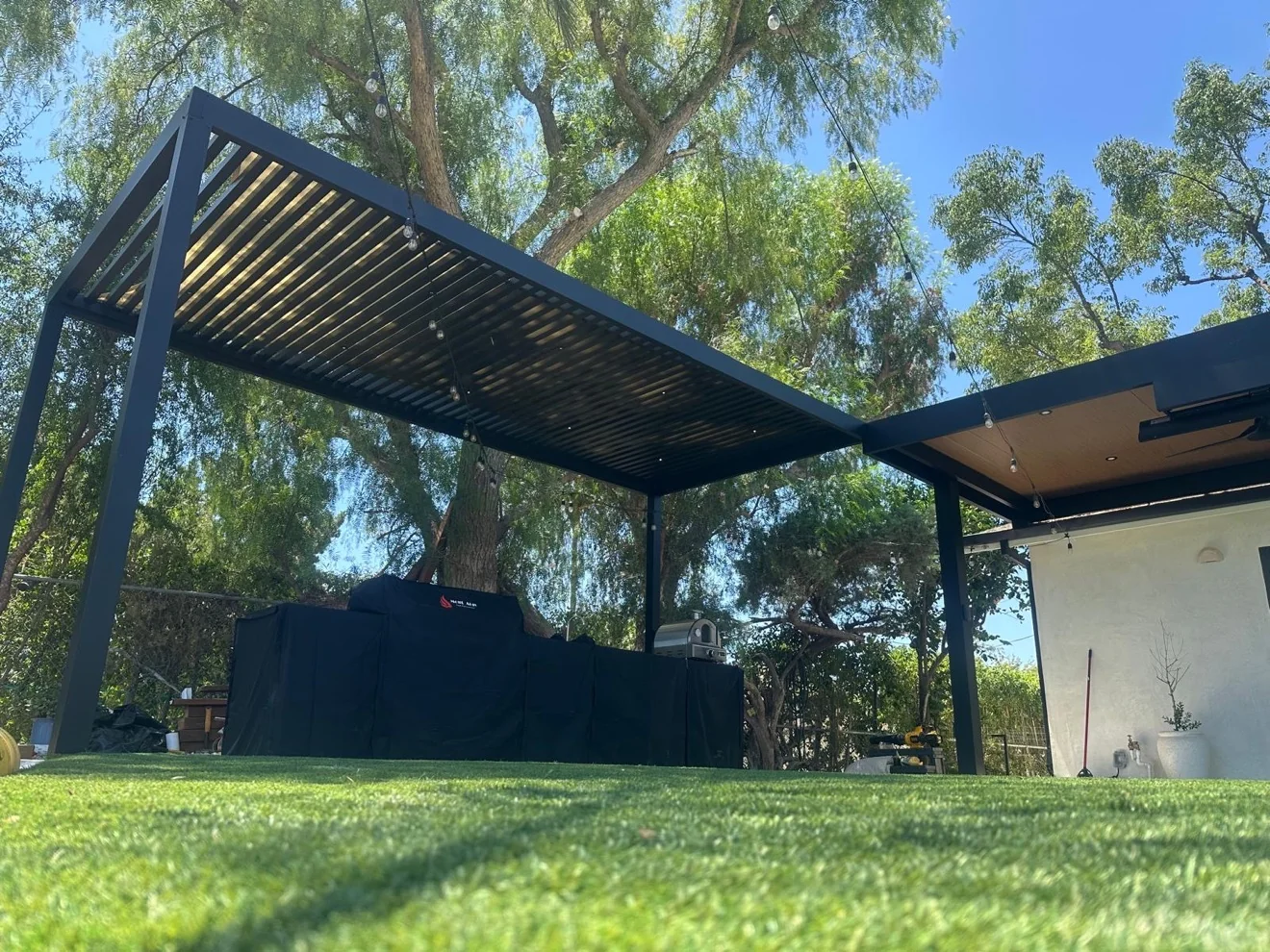 Louvered pergola over turf with outdoor cooking by Moda Outdoor Living in West Hills, CA — luxury outdoor living design and build