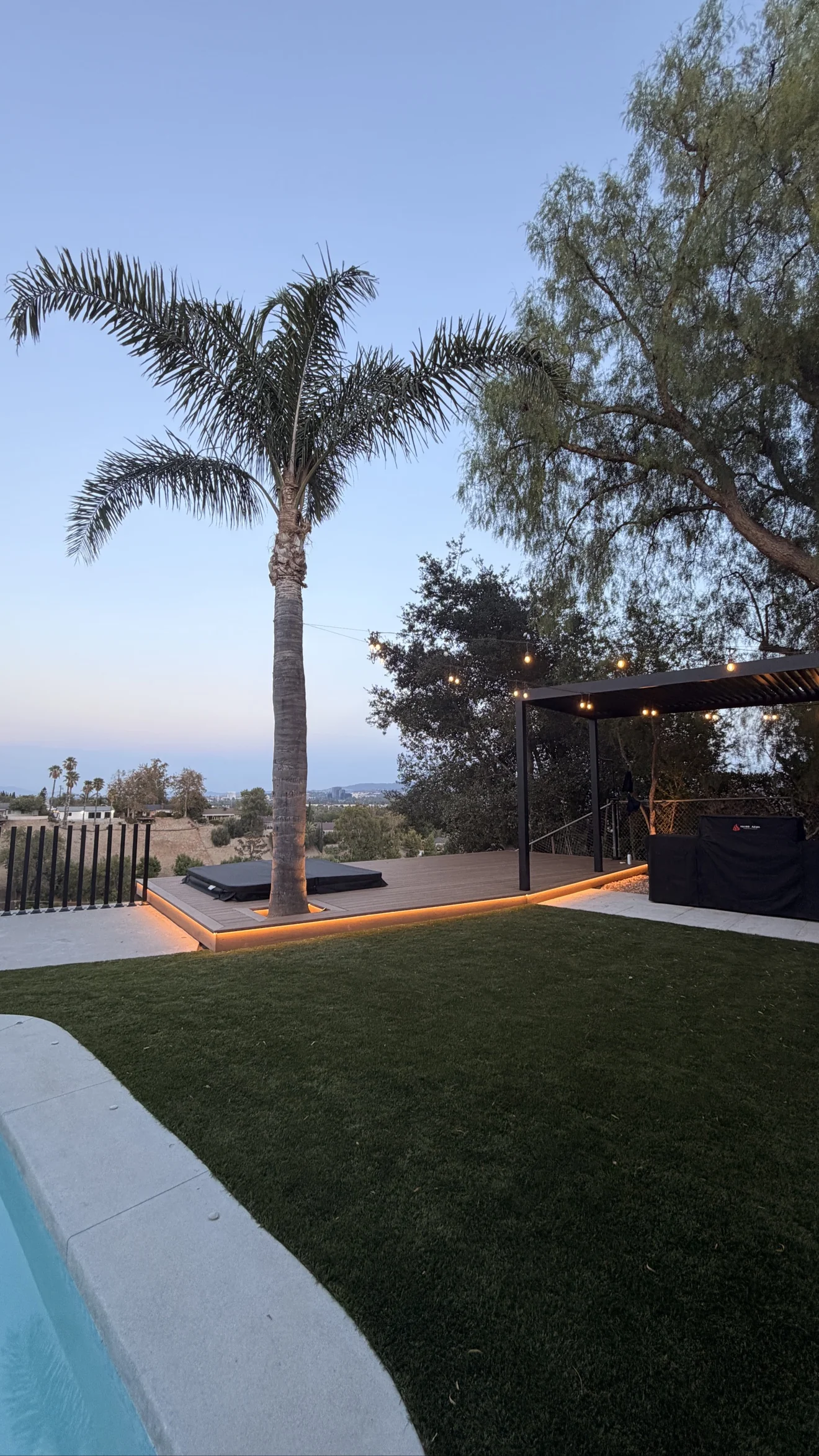 Hillside deck with spa and pergola at dusk by Moda Outdoor Living in West Hills, CA — luxury outdoor living design and build