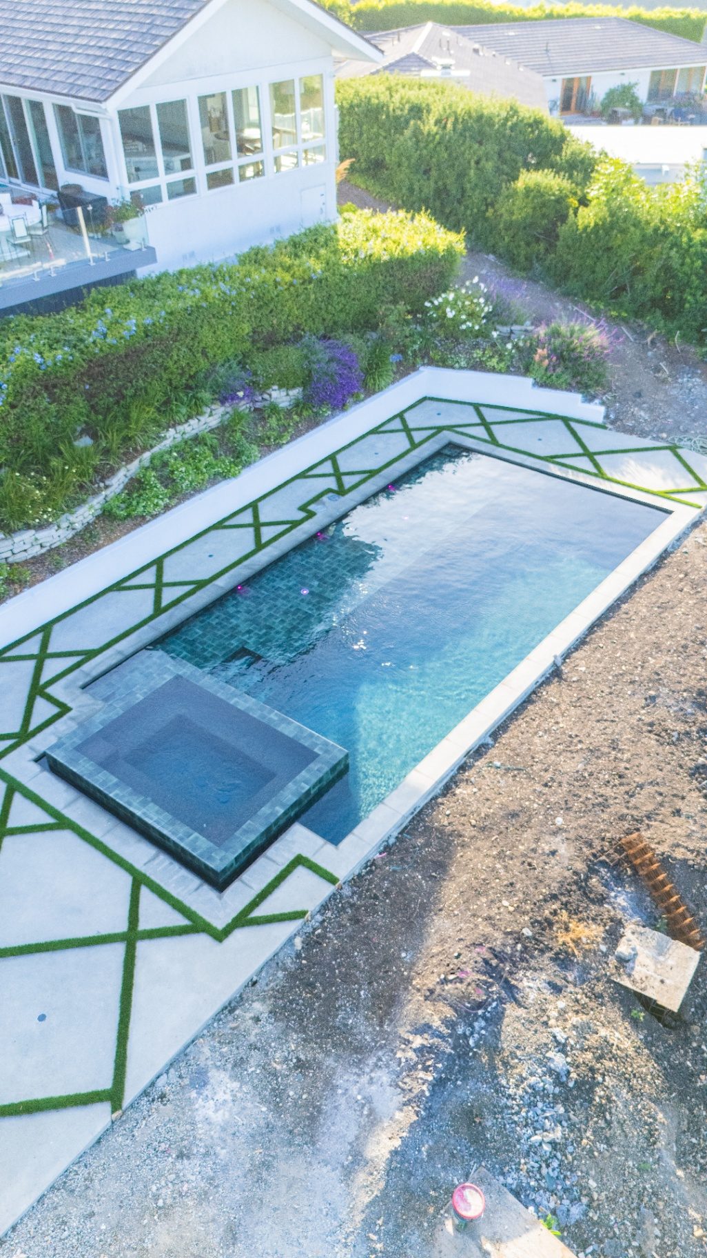 Aerial view of pool deck with geometric turf pattern