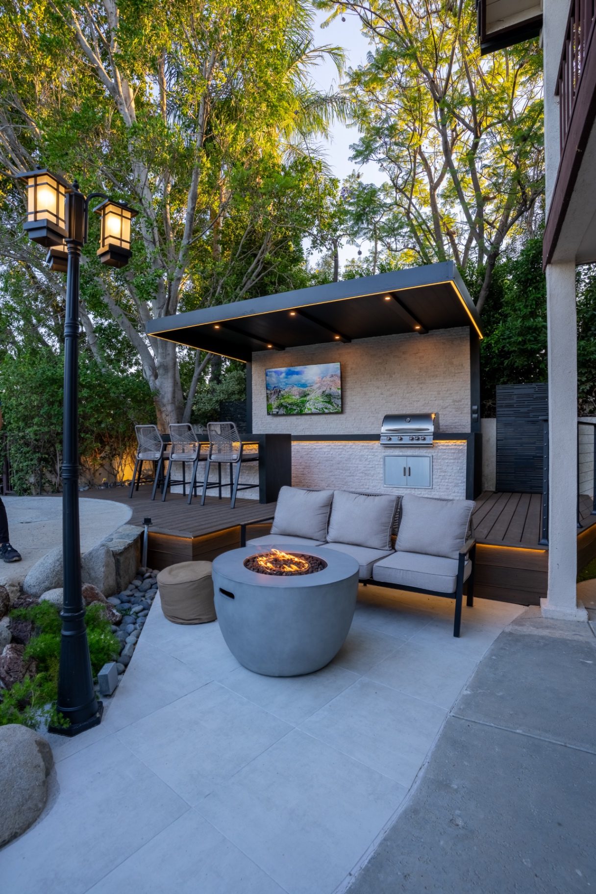 Year-round outdoor living space with fire pit, covered patio, and lounge seating