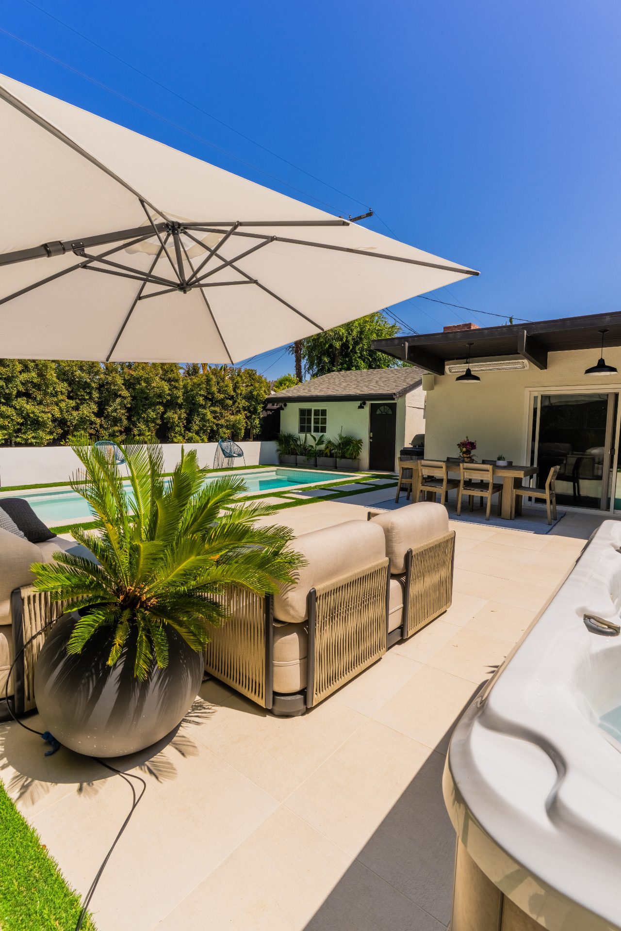 Mid-range backyard with patio, fire pit, and landscape design