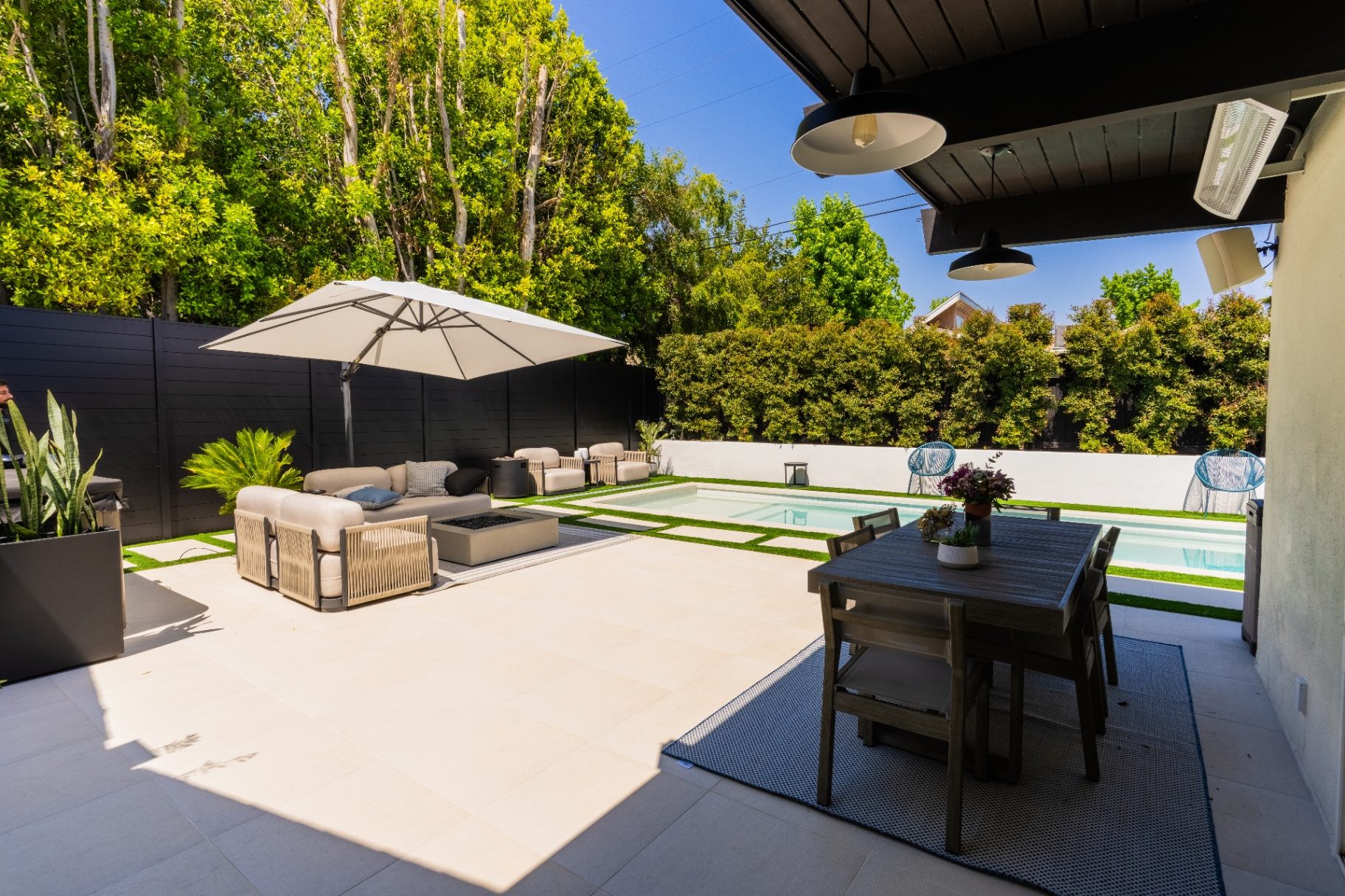 Porcelain paver pool deck installation with modern furniture