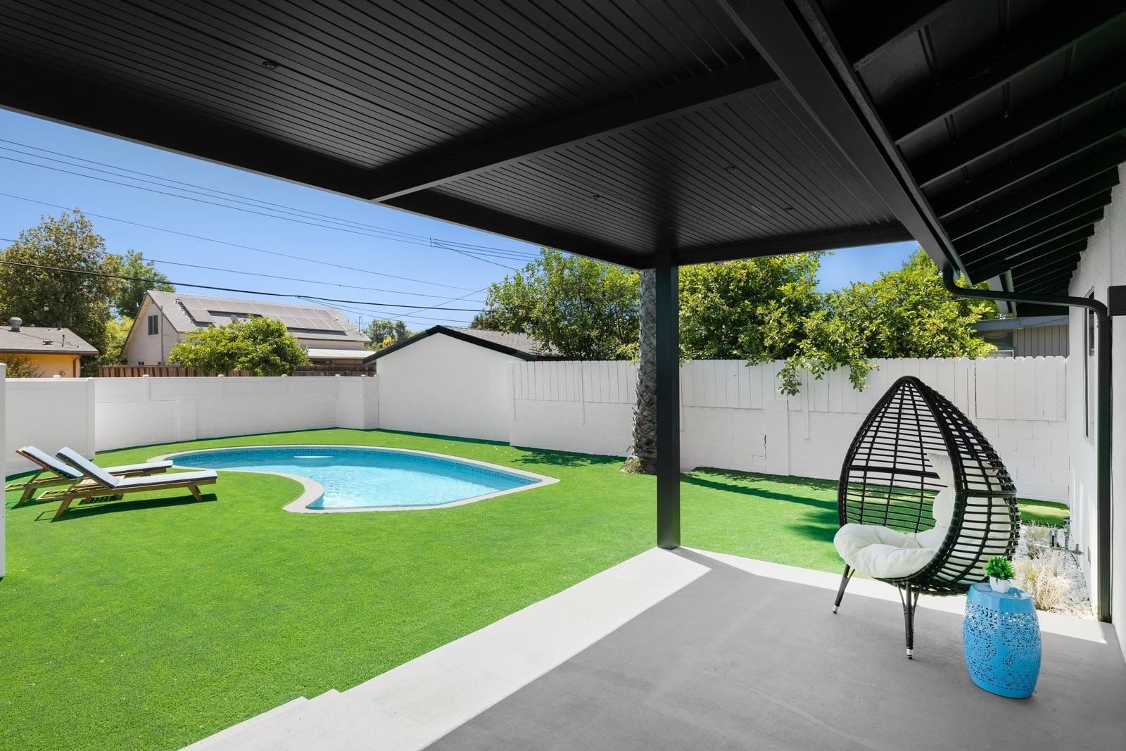 Modern pergola with bar seating and outdoor kitchen