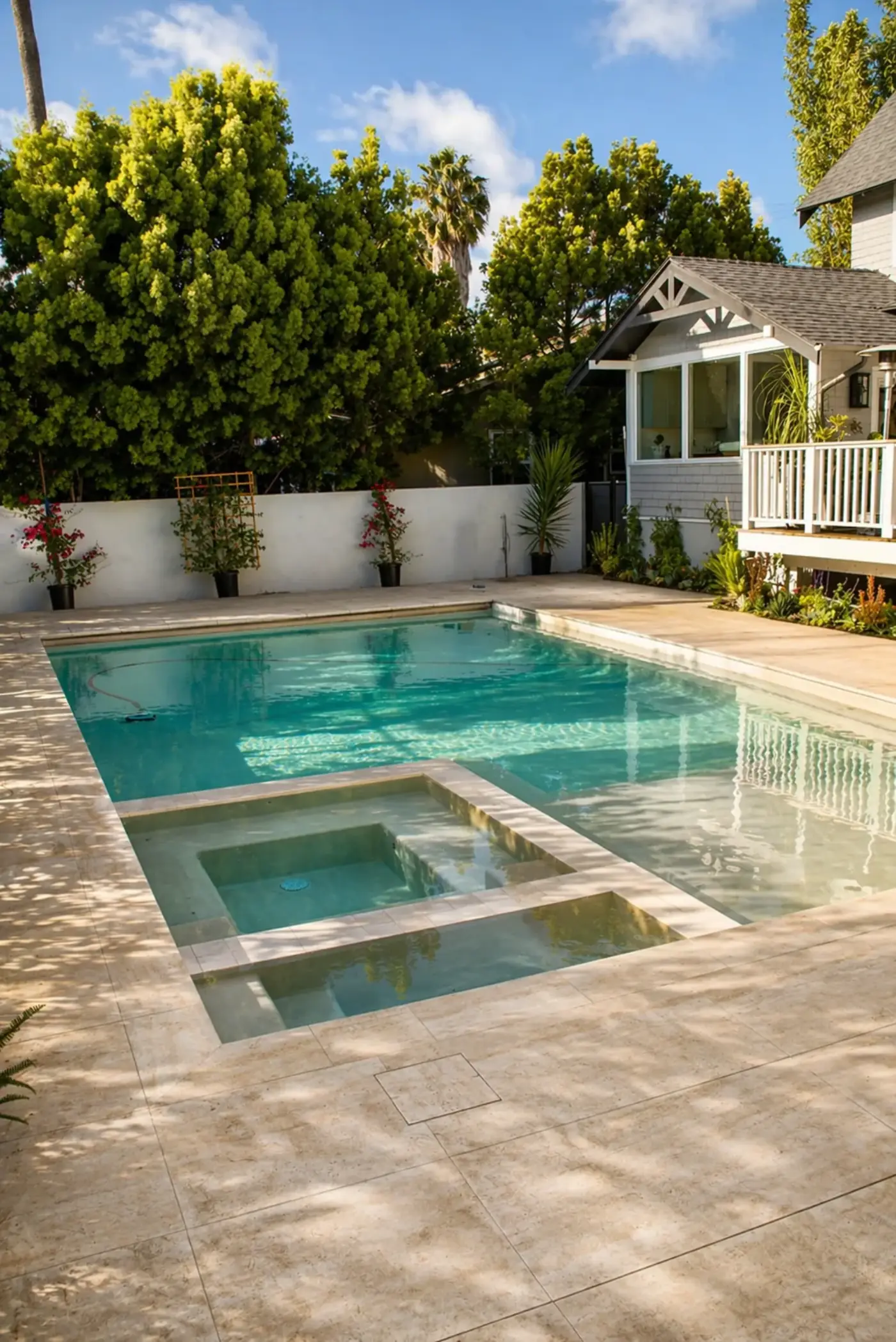 Classic Pool & Spa with Travertine Deck — luxury outdoor living design and build by Moda Outdoor Living