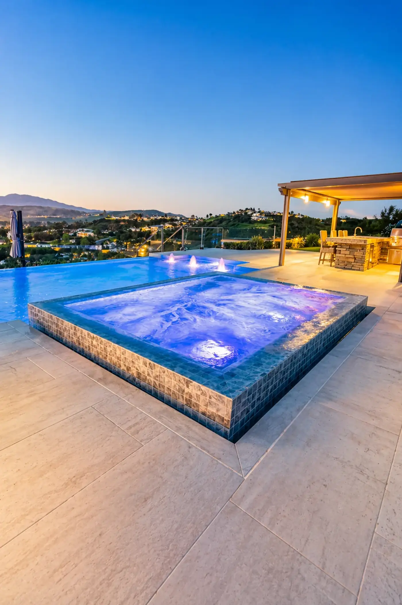 Infinity Spa Terrace with Hillside View & Outdoor Kitchen — luxury outdoor living design and build by Moda Outdoor Living