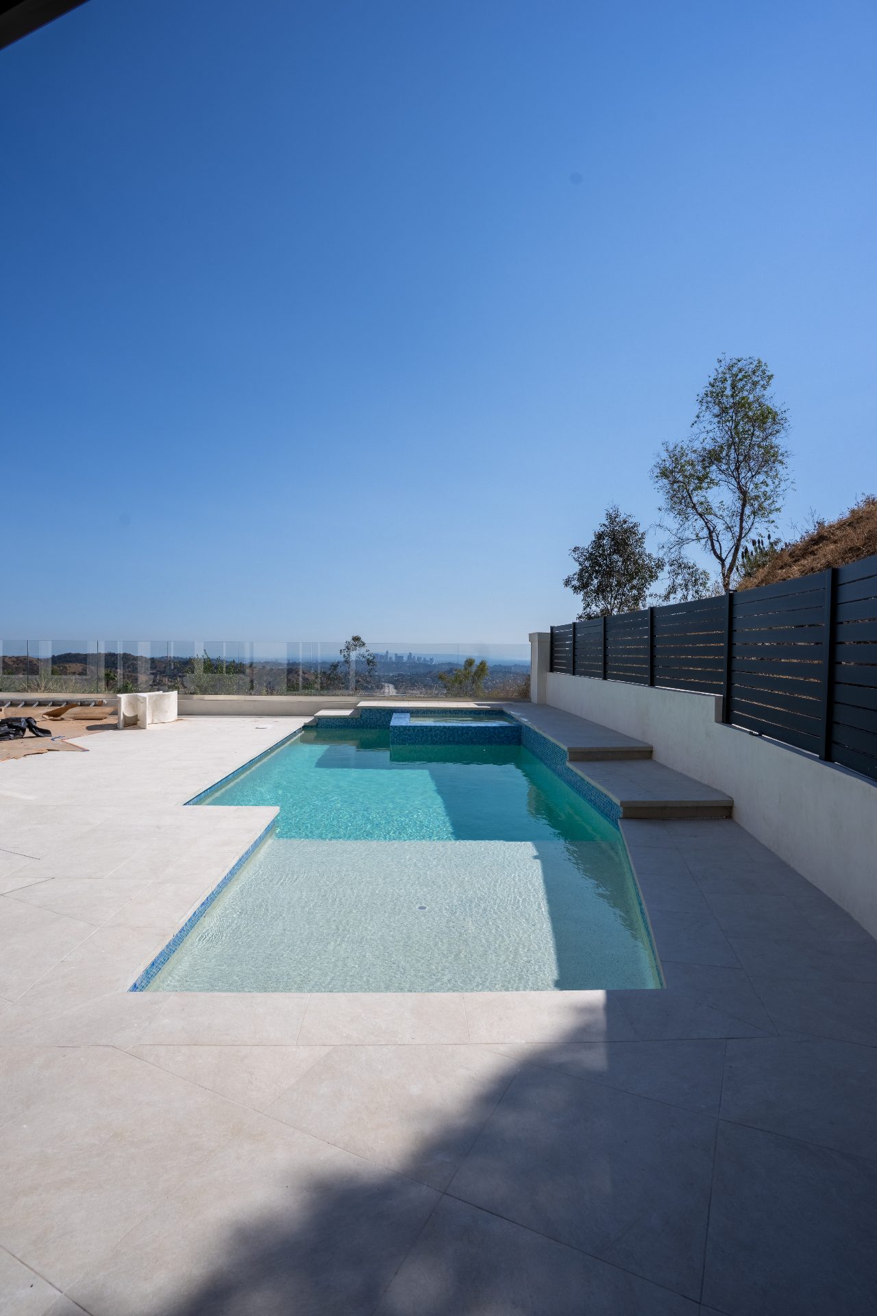 Modern pool with safety features and lounging area