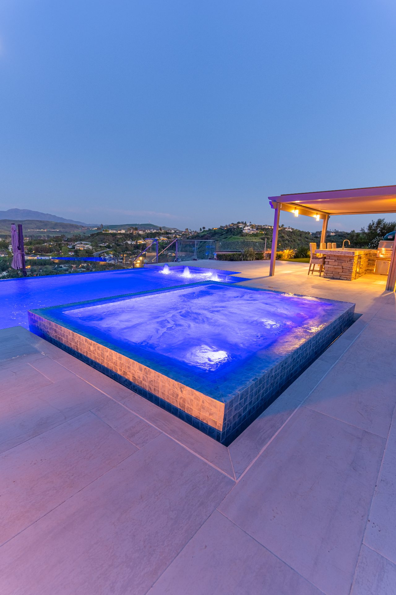 Infinity edge spa at sunset with water cascading over edge