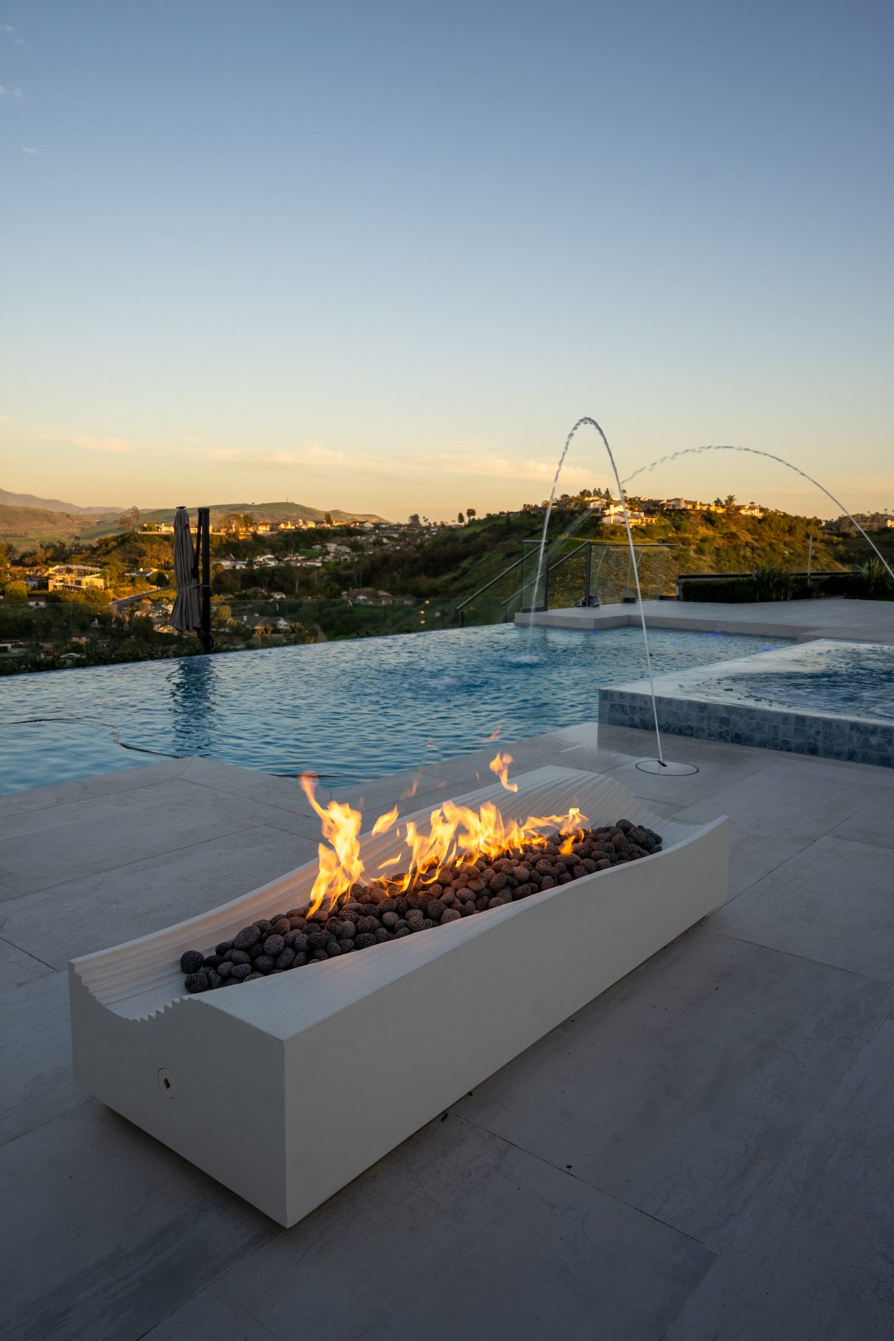 Luxury backyard with infinity pool, fire features, and panoramic views