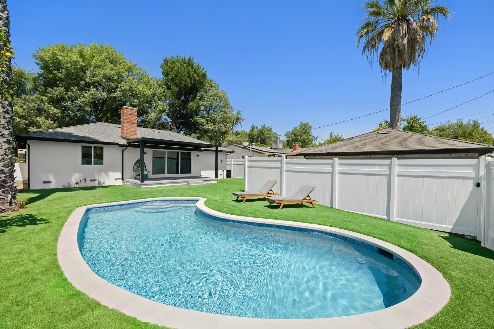 Pool with baja shelf and lounge chairs