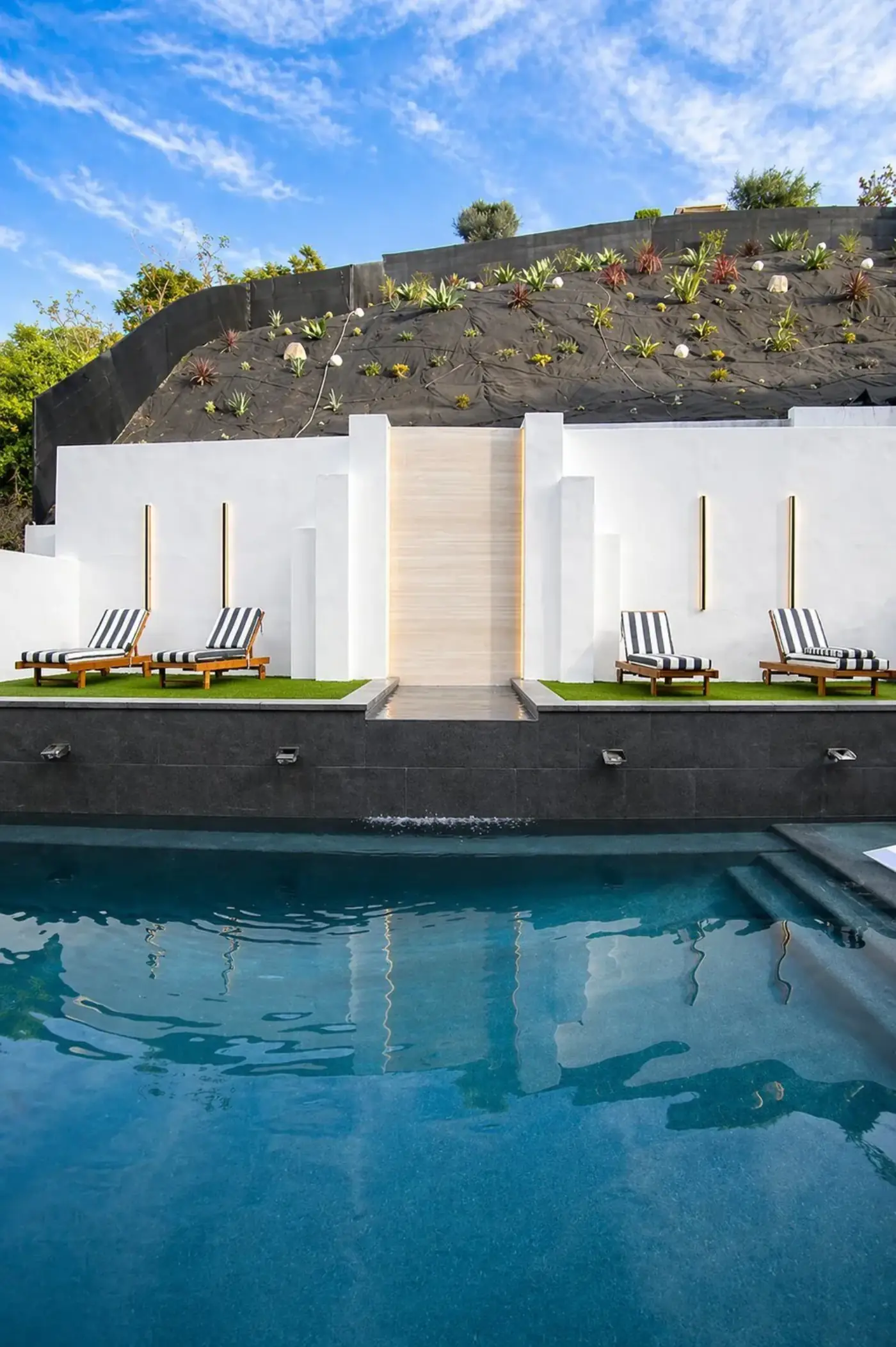 Waterfall Pool with Lounge Area by Moda Outdoor Living in Baldwin Hills, CA — luxury outdoor living design and build