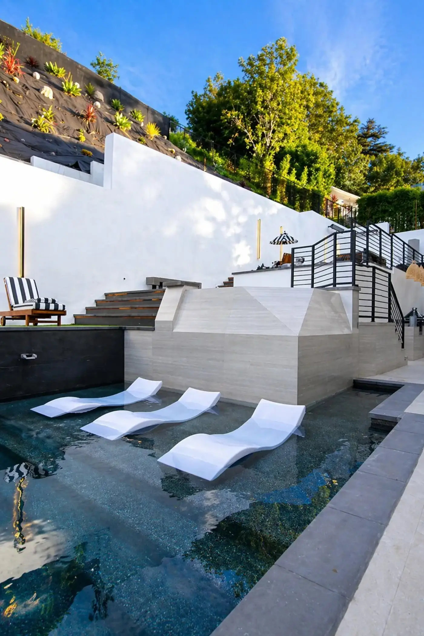 Modern Pool with In-Water Loungers by Moda Outdoor Living in Baldwin Hills, CA — luxury outdoor living design and build