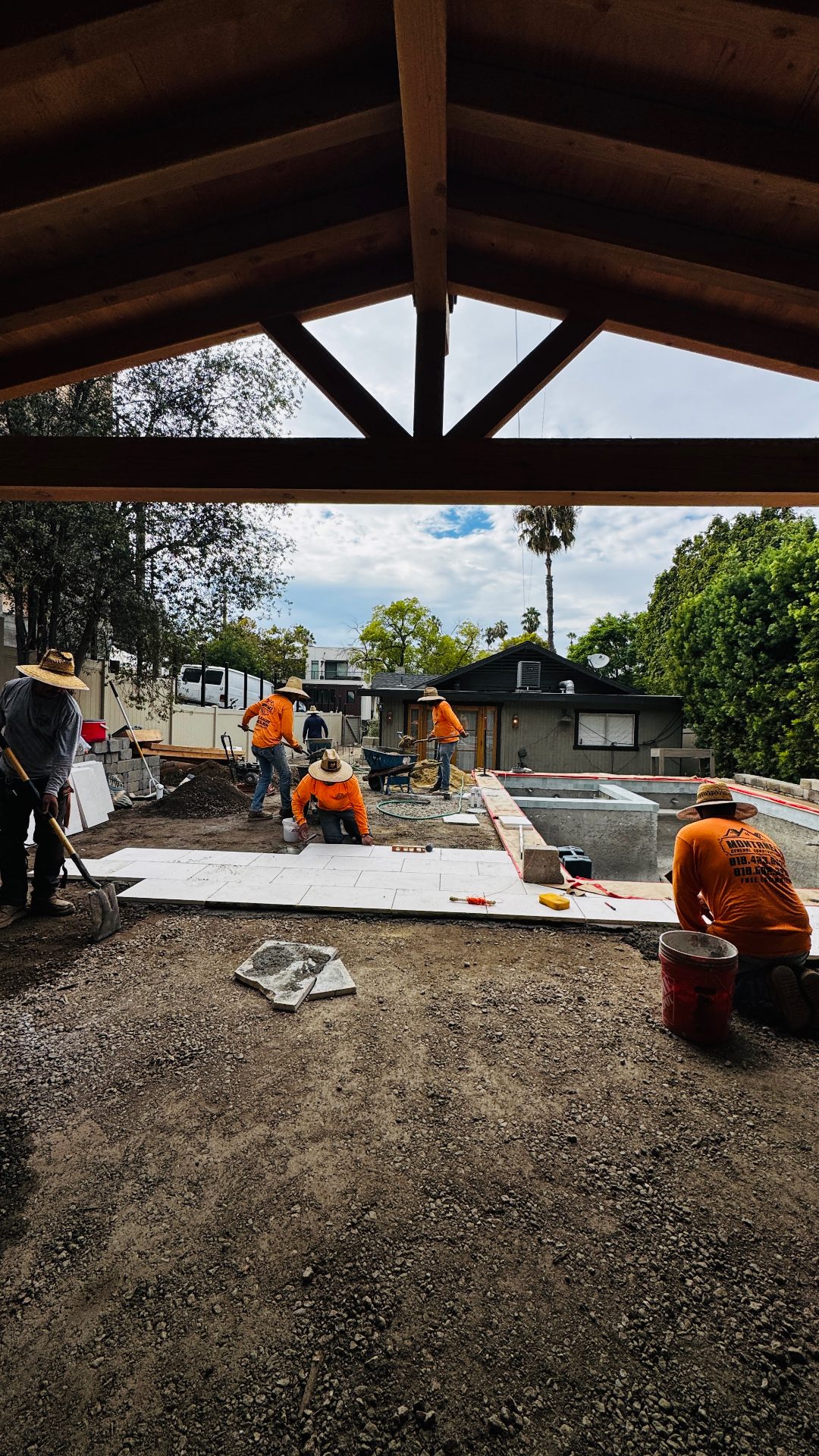 Moda team evaluating site conditions for backyard project