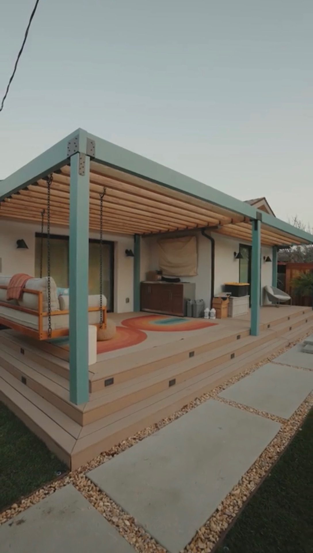 Wood pergola with swing and deck seating area