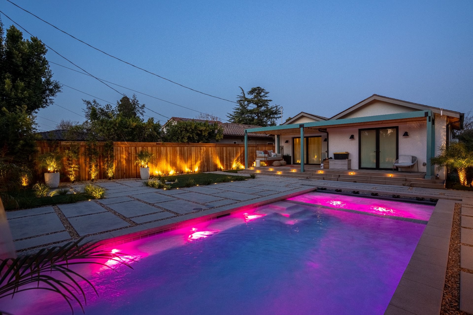 Pool with LED lighting at twilight showing wellness features