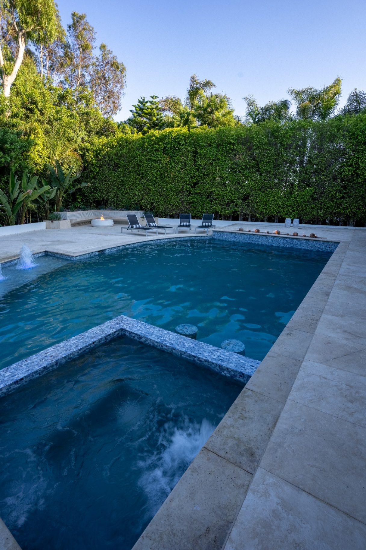 Raised spa with water feature at twilight showing design details