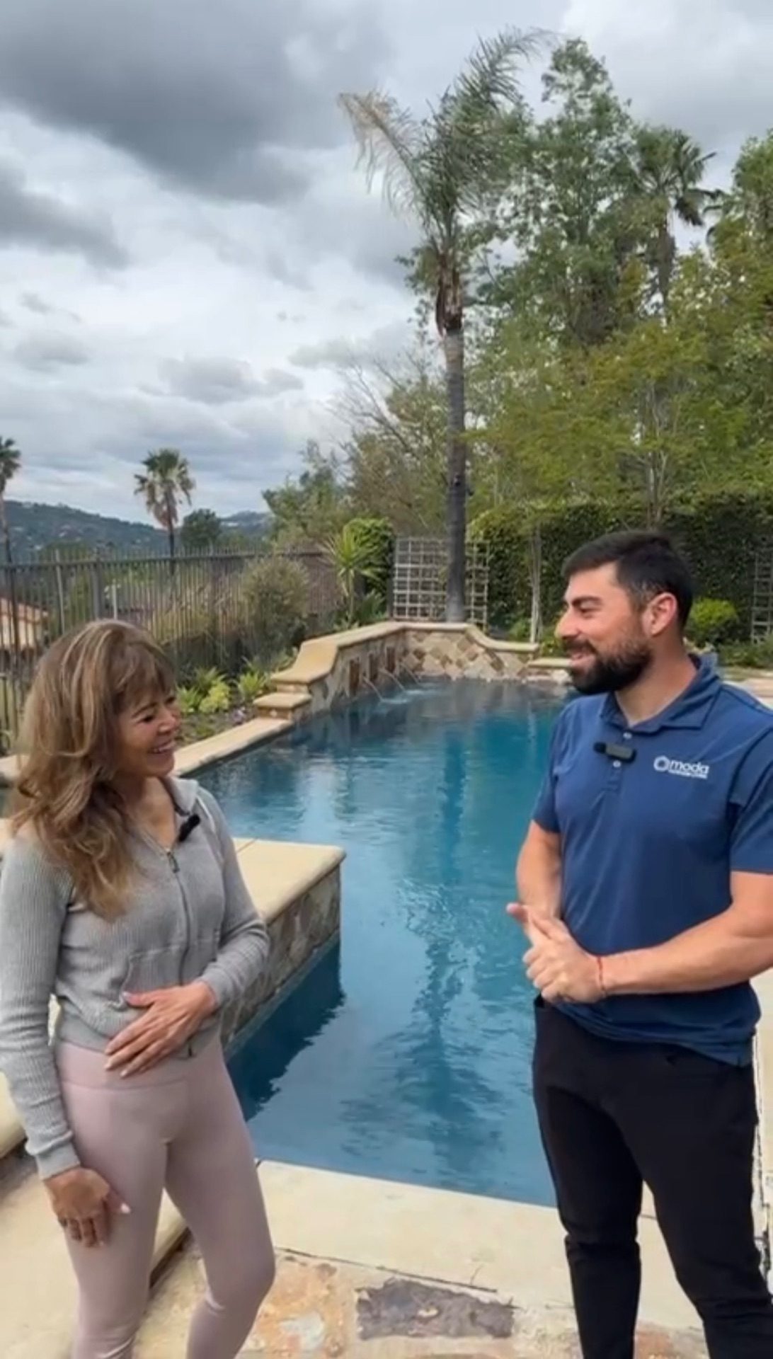 Discussing site measurements and design plans with homeowner