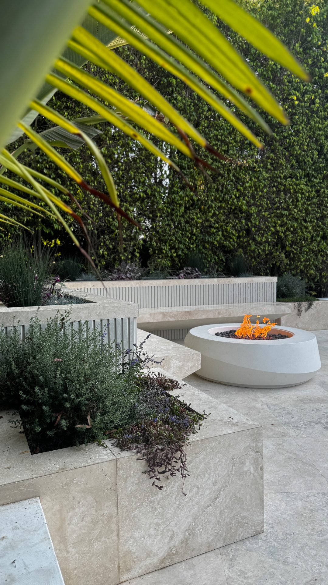 Travertine paver patio with fire bowl - Moda Outdoor Living Los Angeles