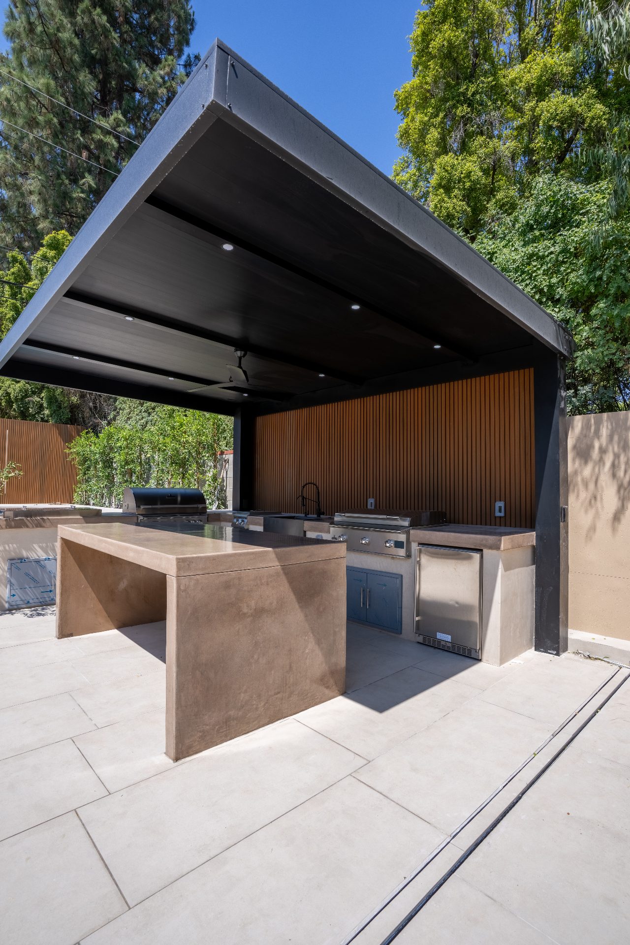 Artificial turf with decorative paver pattern surrounding a swimming pool in Los Angeles
