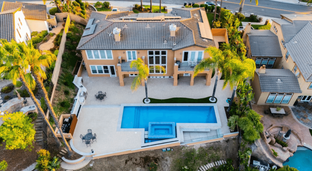 Custom in-ground pool in a Los Angeles backyard with surrounding deck, illustrating typical construction features and size