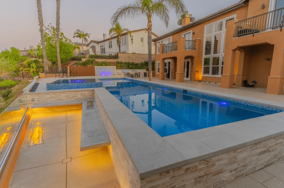 Compact backyard with a built-in corner fire feature, creating a cozy focal point without taking up space