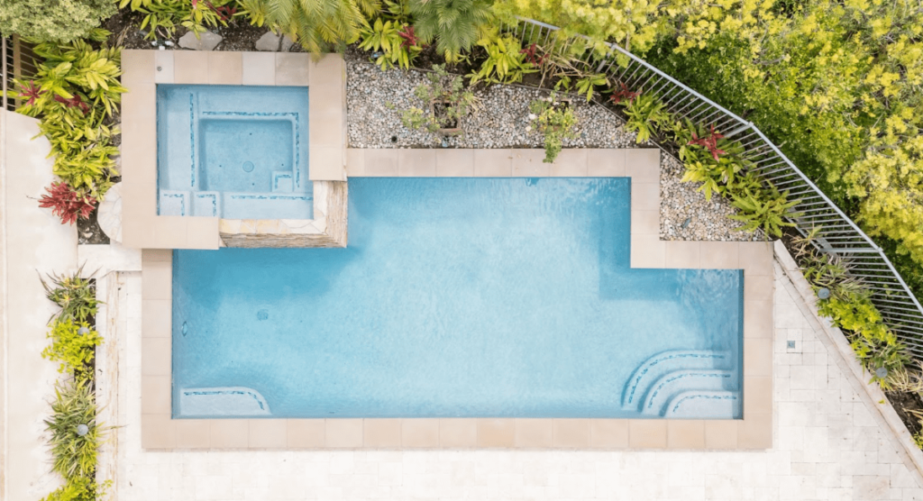 A clean, sunlit pool in Southern California featuring a light-colored interior finish. These finishes help reflect sunlight and reduce heat absorption, making the water more refreshing during hot weather and enhancing the pool’s bright, modern aesthetic.