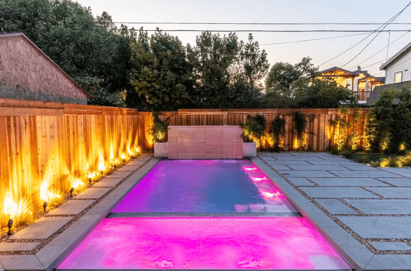 Backyard pool in California illuminated with soft LED lights for evening safety and ambiance