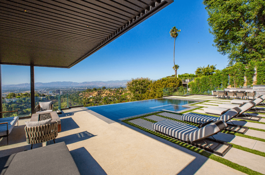 Poolside pergola providing shade over a lounge area in a sunny Southern California backyard