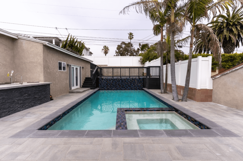 Well-designed small backyard with built-in seating, pavers, and vertical greenery for functional outdoor living