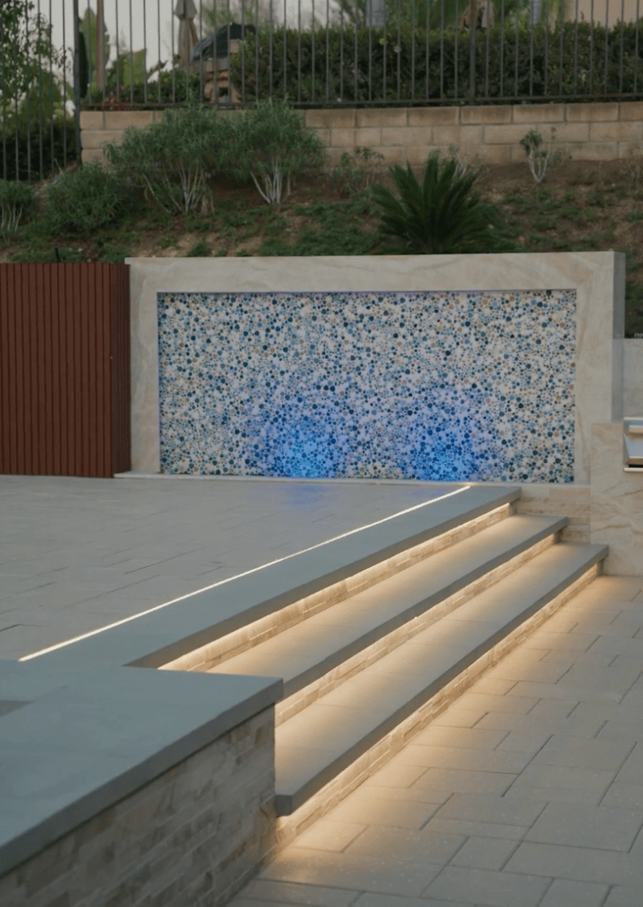 Illuminated pool steps with built-in niche lights for safe entry and exit
