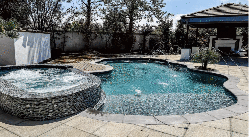 Close-up of various patio paver types including concrete, stone, and brick arranged in a modern backyard layout