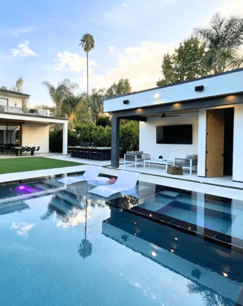 Underwater LED lights illuminating a backyard pool in Los Angeles at night